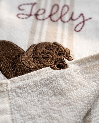 Macro close-up of the embroidered pet portrait and stitched name