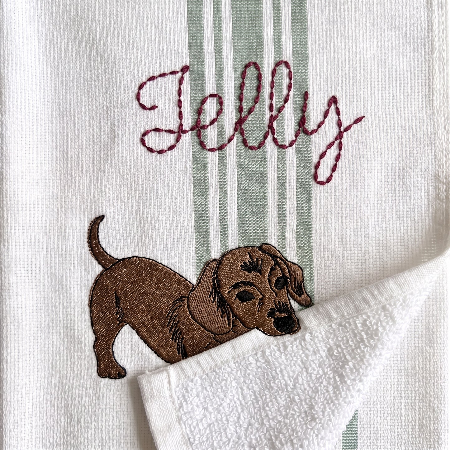 Example dachshund embroidery named Jelly on the green stripe towel