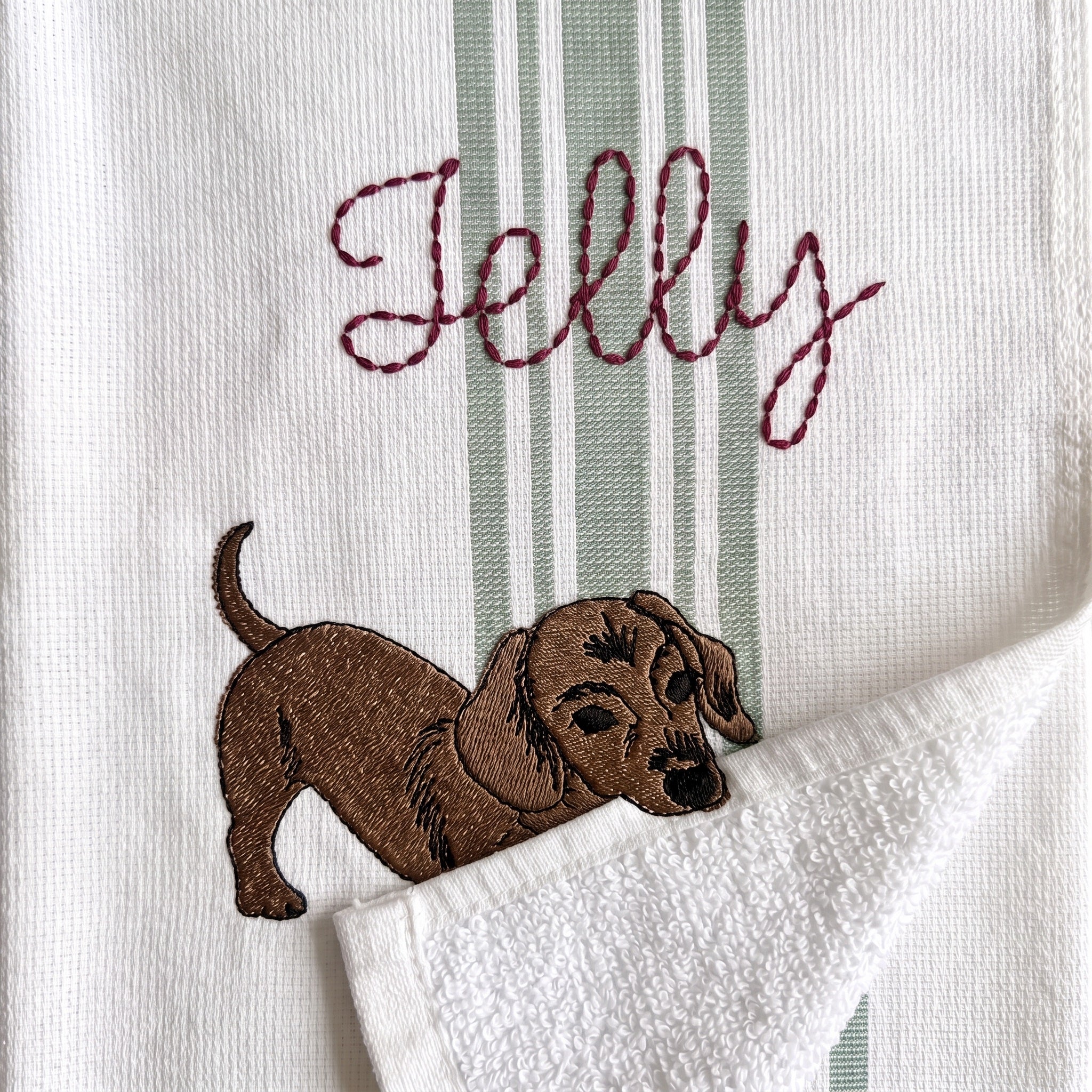 Example dachshund embroidery named Jelly on the green stripe towel