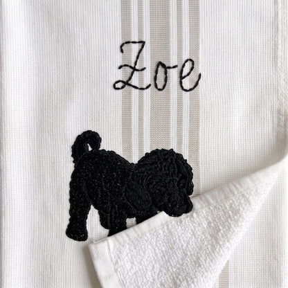 Example curly black pup embroidery named Zoe on the gray stripe towel